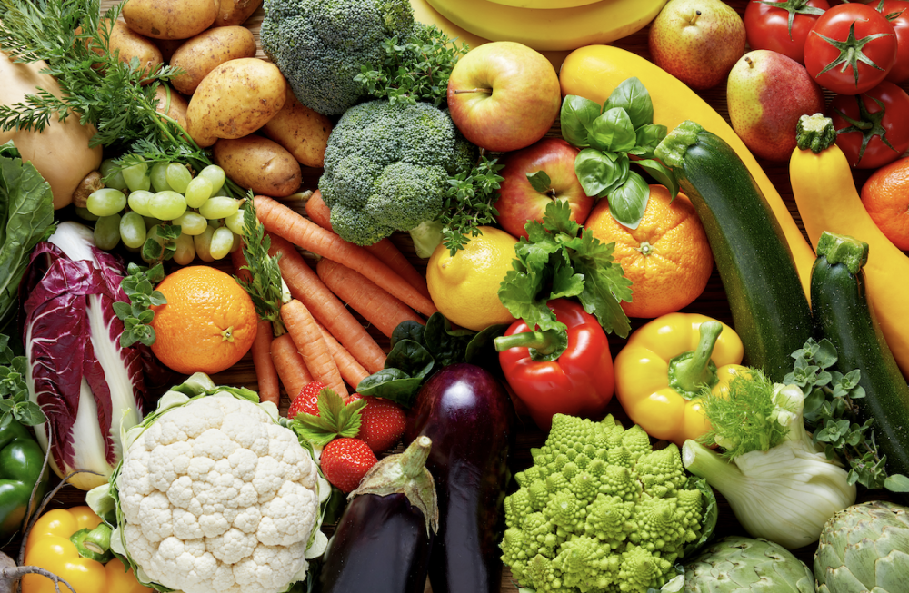 Overhead photo of colorful assortment of fresh fruits and vegetables