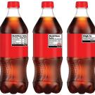 Five plastic bottles of cola with red labels and varying designs, lined up.